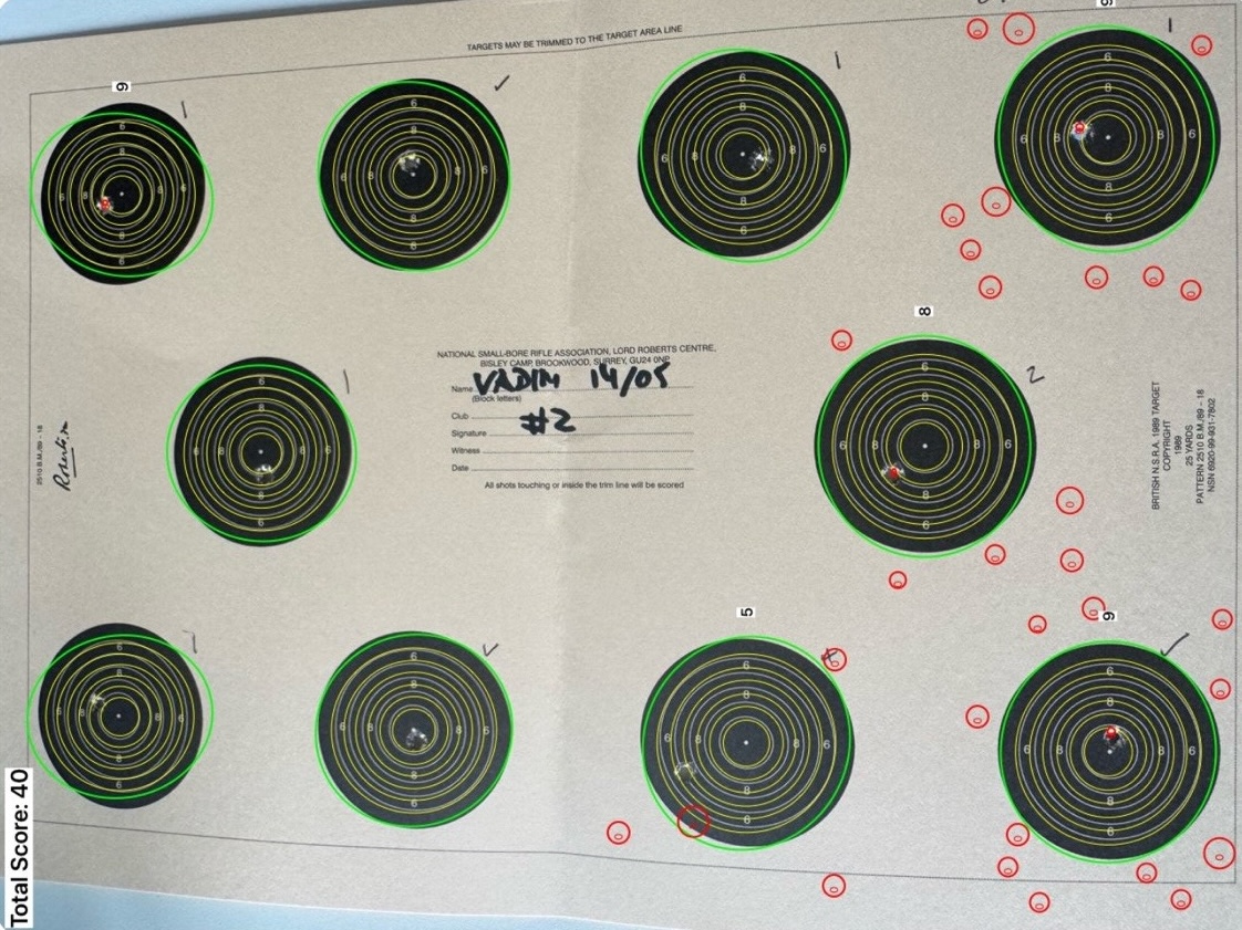 A ten-bull NSRA competition card photographed at a slight angle. Green ellipses are drawn around each detected bull; dozens of small red circles are scattered across the margins where decorative printed dots have been tagged as bullet holes. Total score displayed top-left: 40.