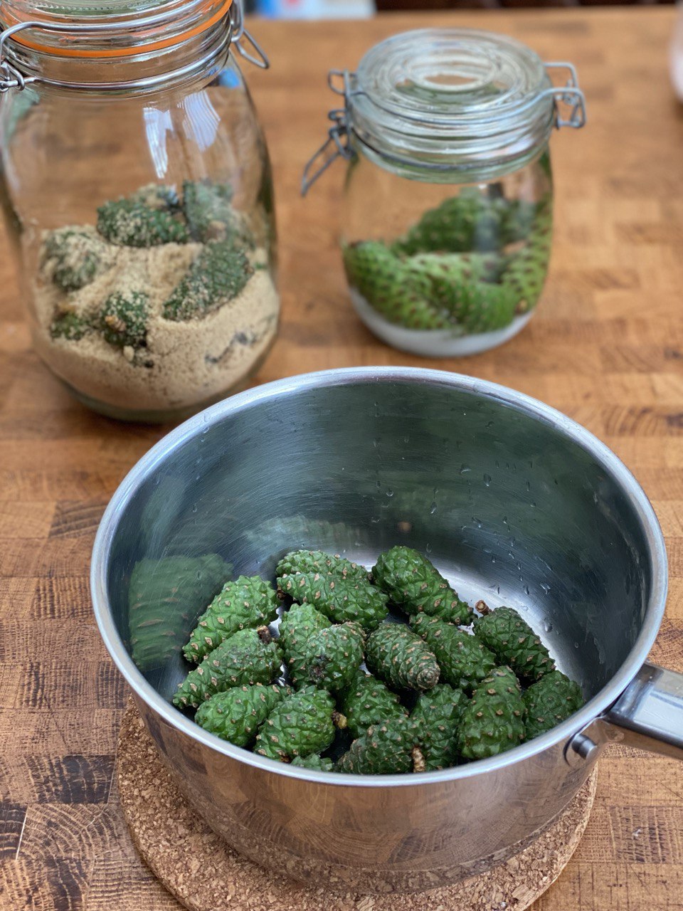 Mugolio preparation: fresh cones and sugar