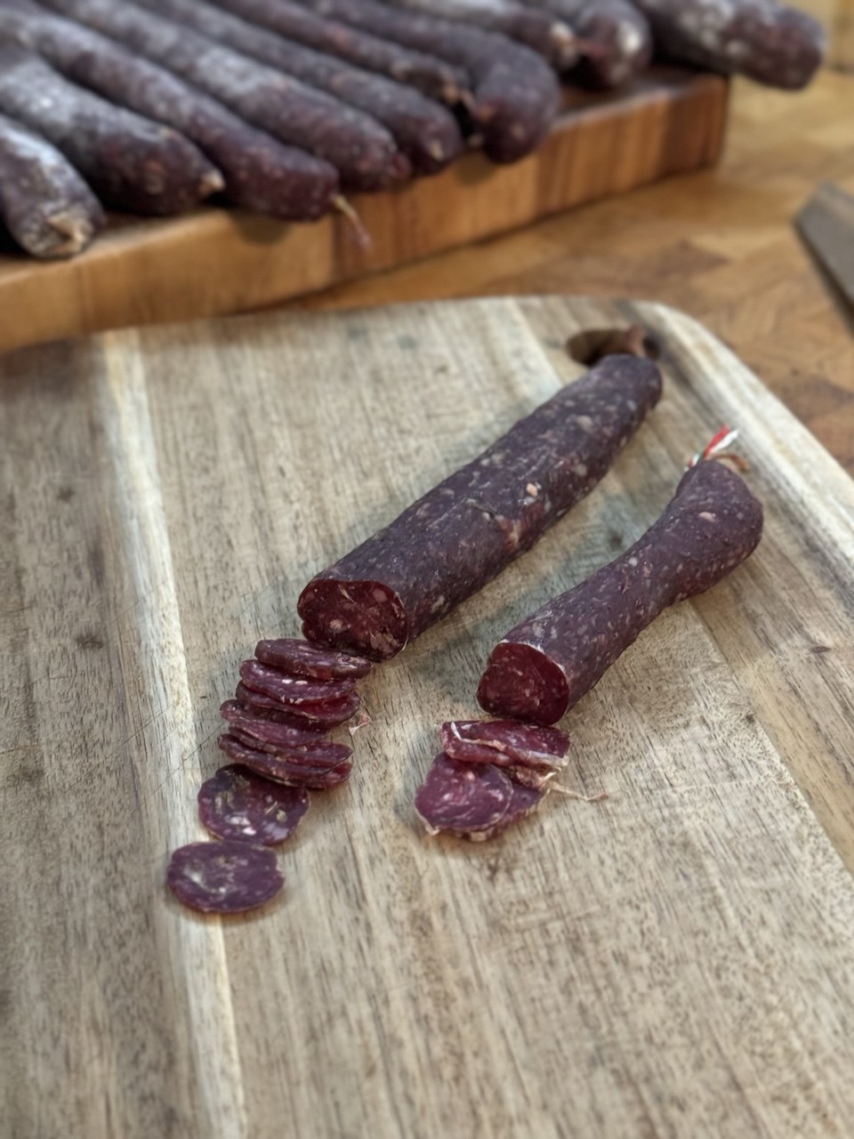 Sliced venison salami on the cutting board.